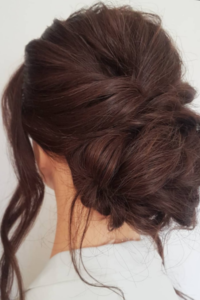 Low Messy Bun with Loose Strands