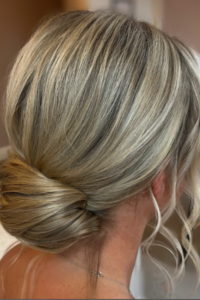 Low Messy Bun with Loose Strands